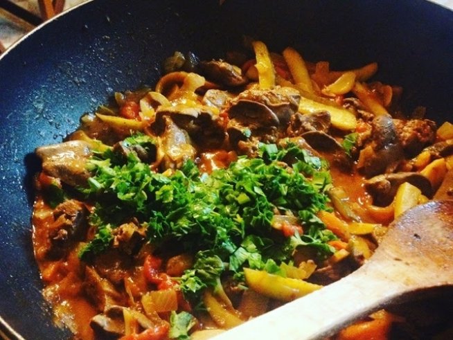 500 г пилешки дроб
2 глави лук
2-3 скилидки чесън
5-6 кисели краставички
4-5 червени печени чушки
1/2 връзка пресен магданоз
150 мл доматено пюре
малко кафява захар
черен пипер 
сол
зехтин