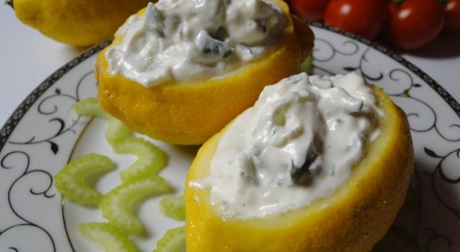 4 едри лимона
1 кофичка цедено кисело мляко
1 дребна краставица нарязана на кубчета
1 стрък целина нарязана на ситно
1 лъжица заквасена сметана
1 лъжица каперси
сол
1 с.л. магданоз нарязан