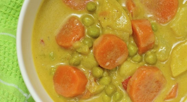 1 кг картофи
500 г грах от консерва
2 моркова
50 мл олио
сол, черен пипер на вкус
4 скилидки чесън
1 супена лъжица доматено пюре
няколко стръка копър