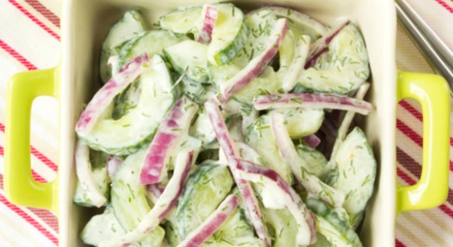 2 големи краставици
няколко листа салата айсберг (по желание)
1 глава лук
1 малка кутийка заквасена сметана
сол, черен пипер
няколко стръка копър
оцет
зехтин по желание